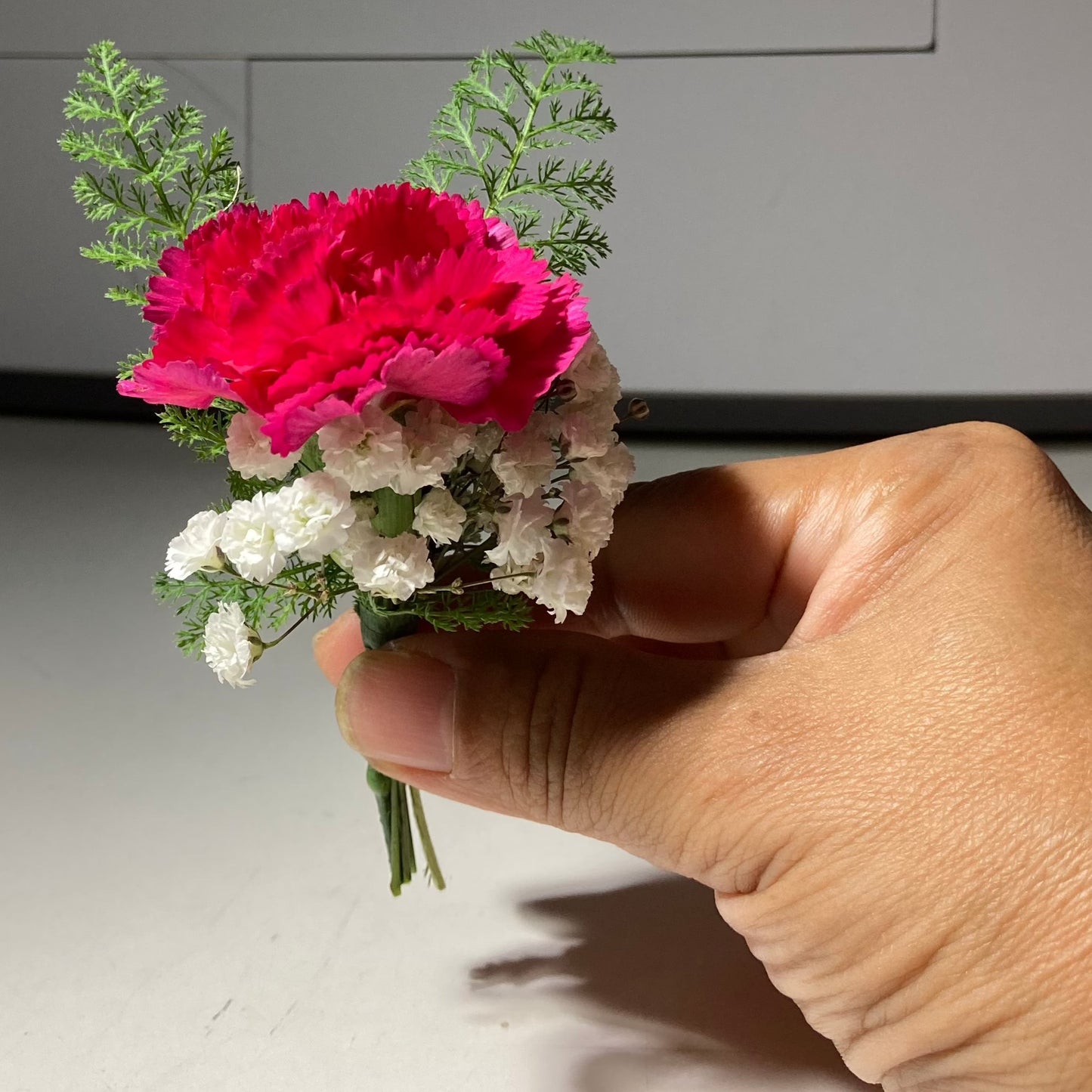 Tinsy button-hole arrangement